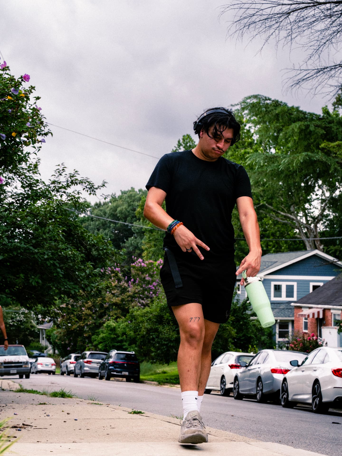 A runner in headphones throwing a hand sign