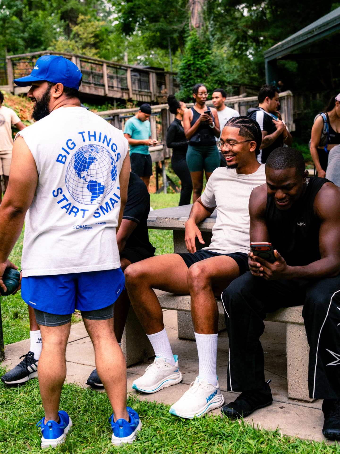 Runners laughing together on the park benches before the start