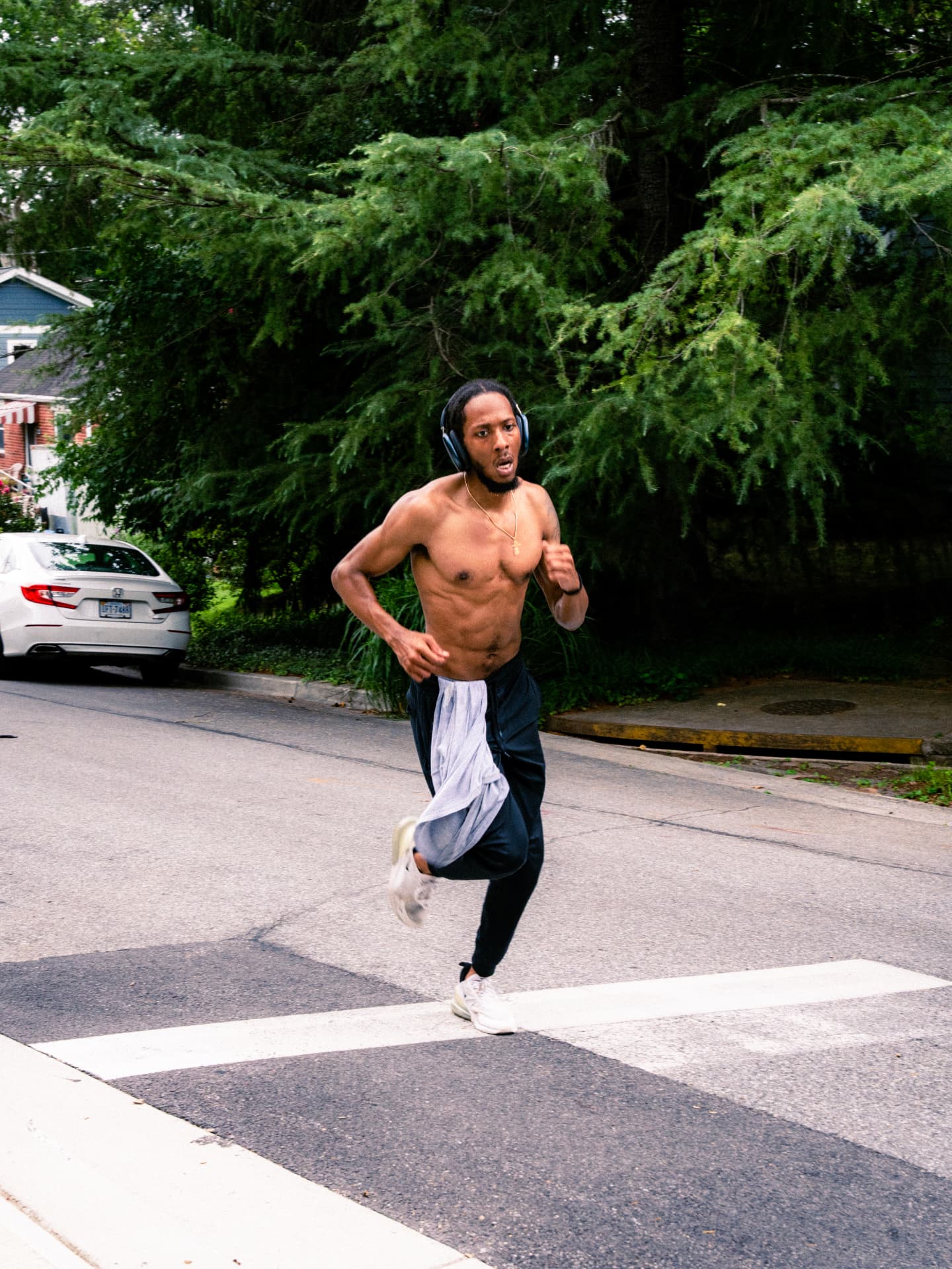 A runner crossing the street in headphones
