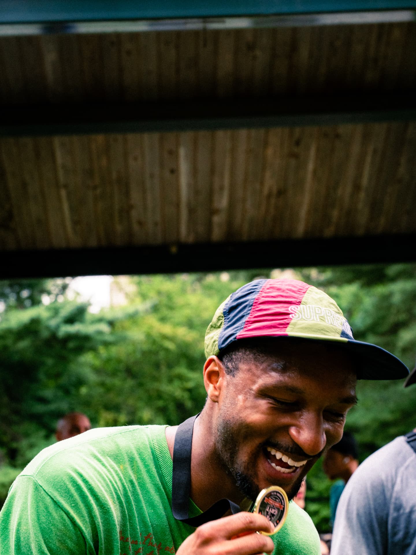 Finisher laughing as he looks at his medal