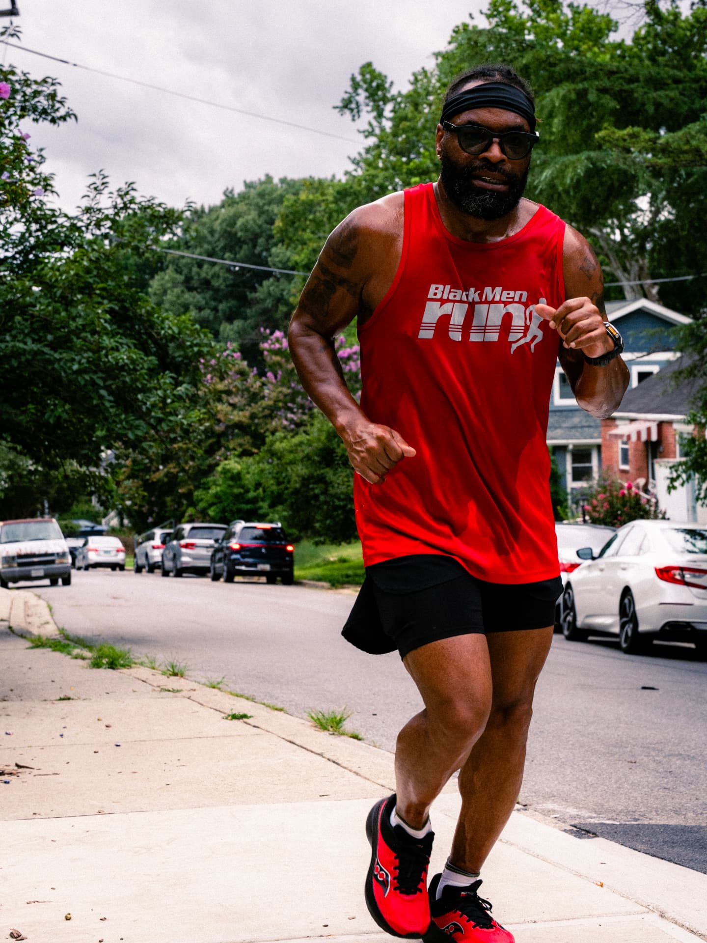 A Black Men Run member in a red tank pushing the pace